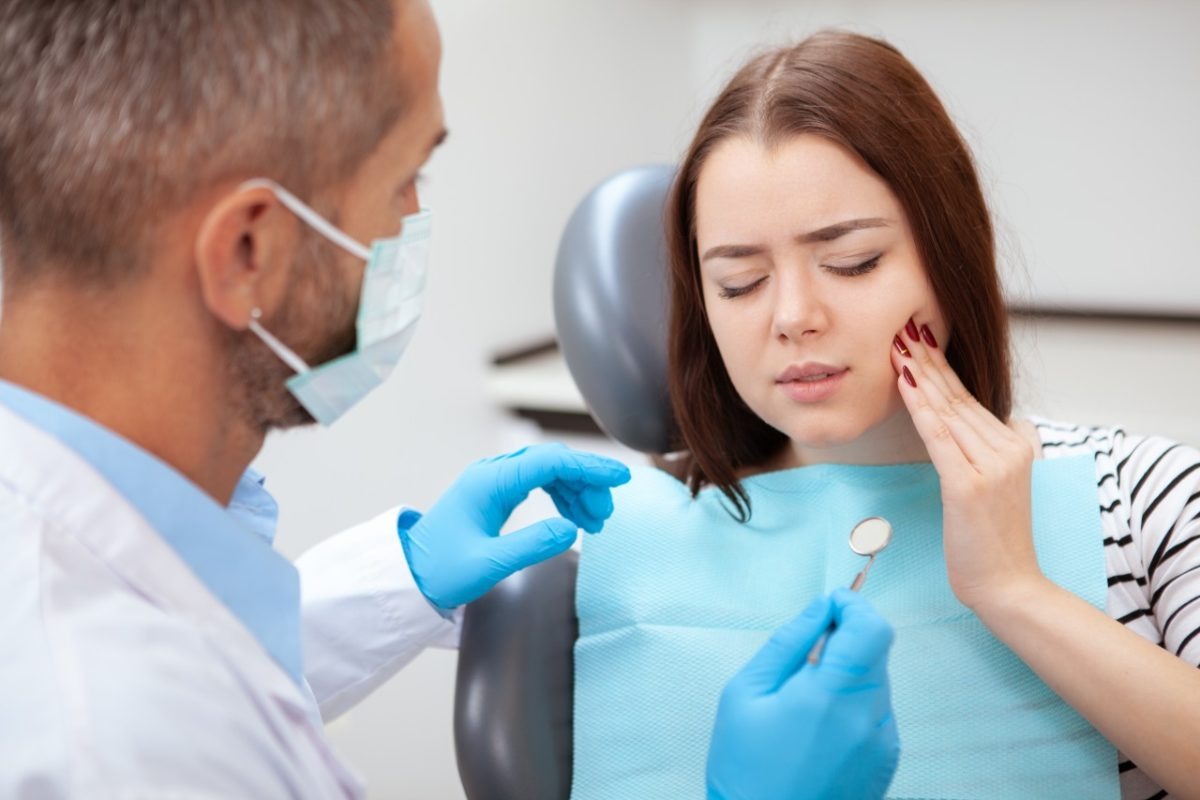 image of Female patient with terrible toothache visiting dentist