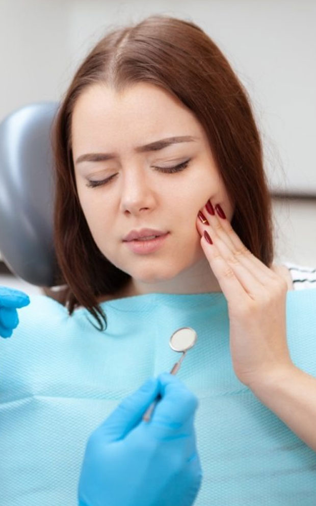 image of Female patient with terrible toothache visiting dentist